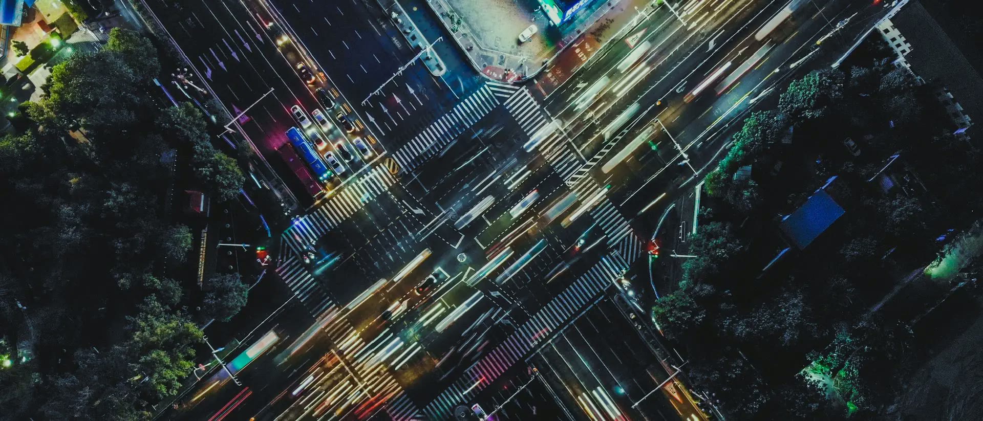 Night aerial view of a city crossroads with light trails